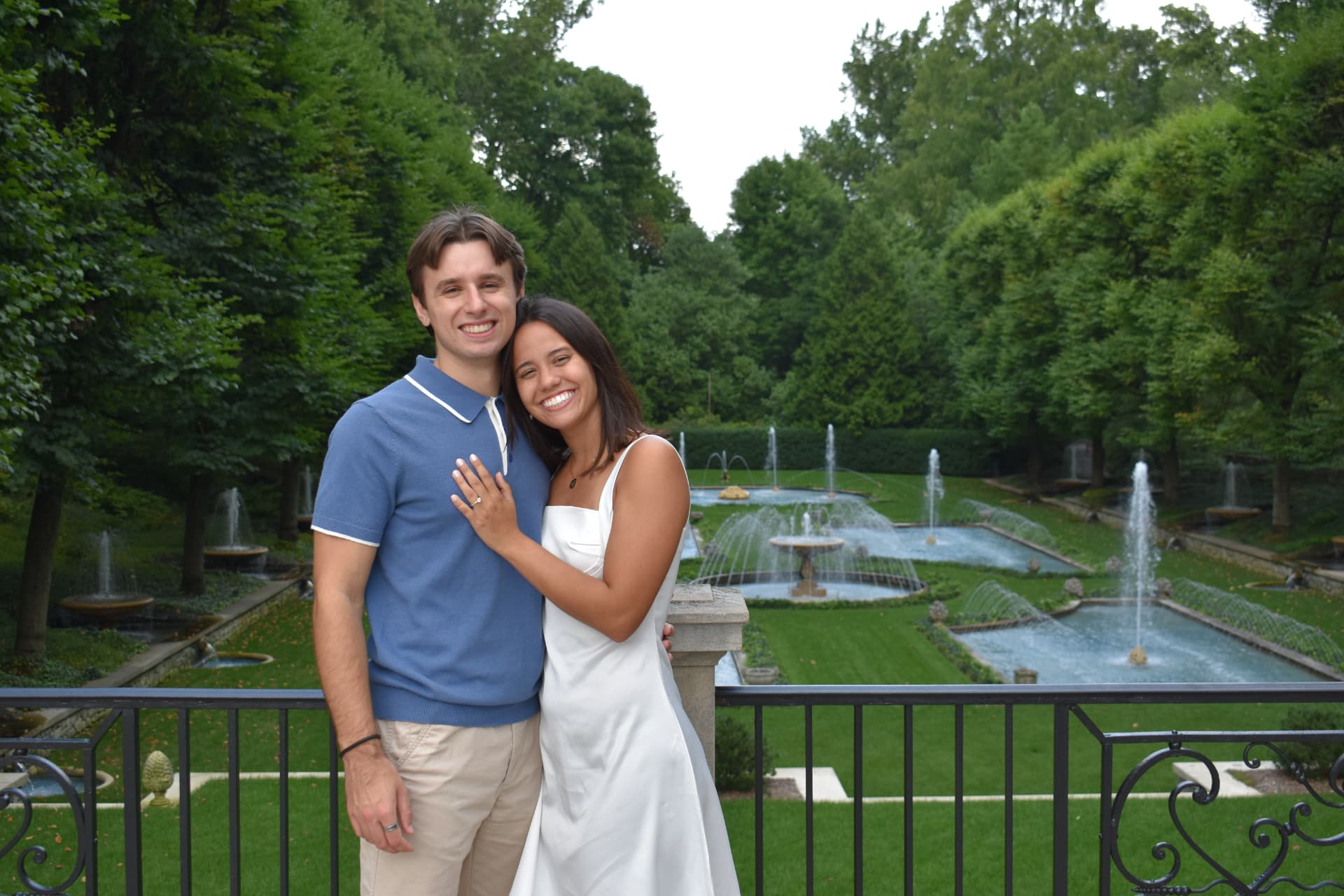 Emily and Thomas smiling together above the fountains at Longwood Gardens.